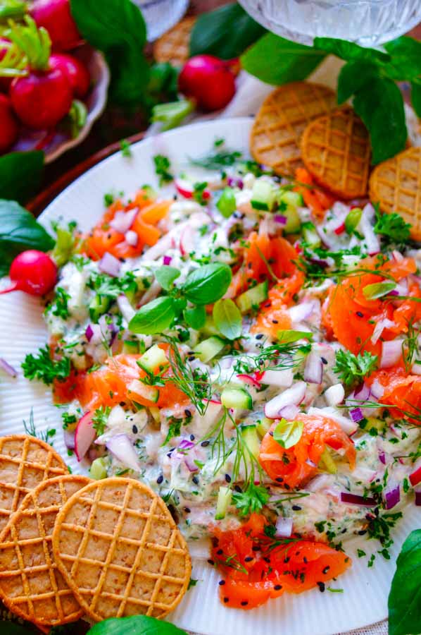 Lekker makkelijk recept voor Zalm Dip, een frisse lichte zomerse dip met gerookte zalm. Een ideaal snel hapje klaar in 20min voor bij de borrel of apero. Een heerlijke combinatie van yoghurt, roomkaas, kruiden, knapperige groentjes en stukjes gerookte zalm. Perfect om in te blijven dippen