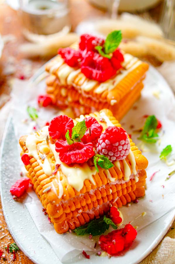 Lekker makkelijk recept voor Petit Beurre taartjes met witte chocolade en frambozen, simpel en klaar in amper 20min. Een koekjestaart zonder boter of koffie. Veel frissen en lichter dankzij de mascarpone en frambozen die we nu gebruiken.